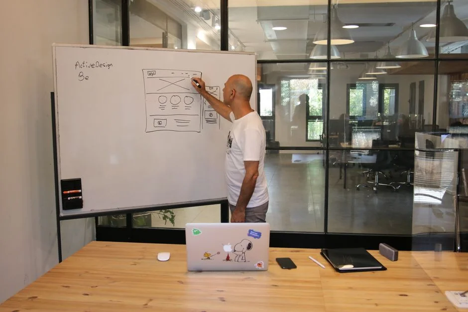 creative Stylish and efficient workspace with multiple monitors, laptop, and smartphone, showcasing a web design project.