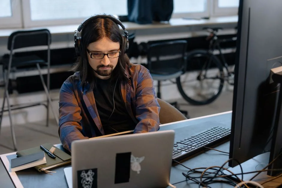 digital Dual monitors on a desk, showcasing web design in a modern office setting.